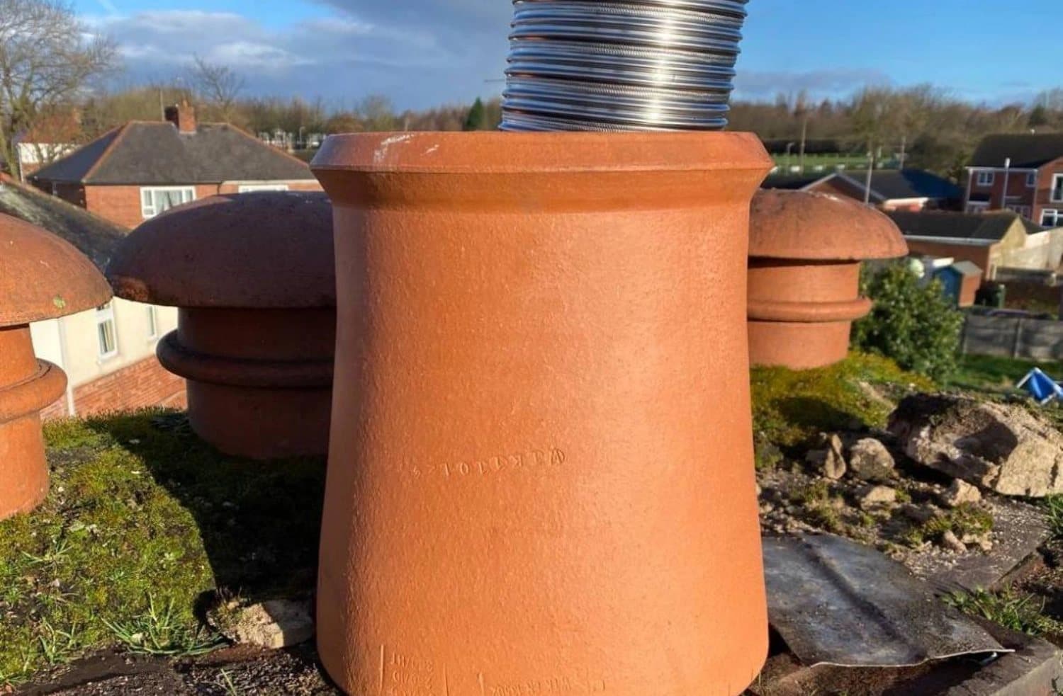 Terracotta chimney pots on a brick stack against the sky