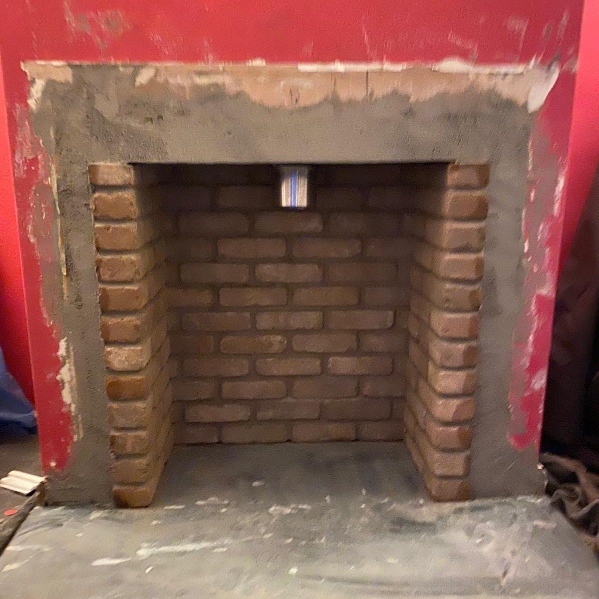 Newly built brick fireplace chamber ready for a fire or stove