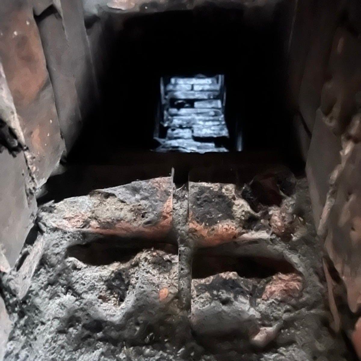 Looking up inside a brick chimney flue before lining and stove installation