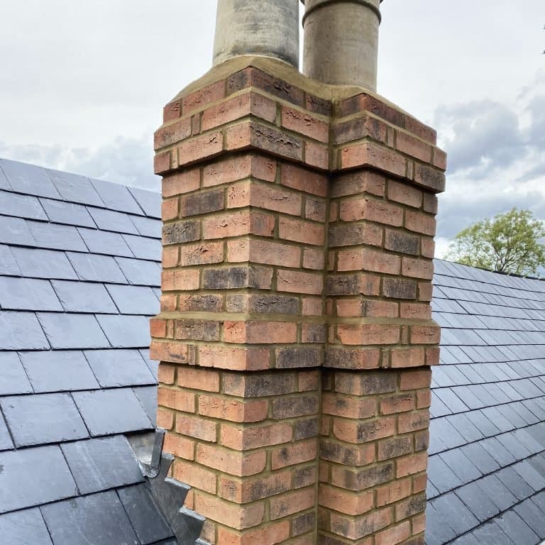 Repointed brick chimney stack on a slate roof